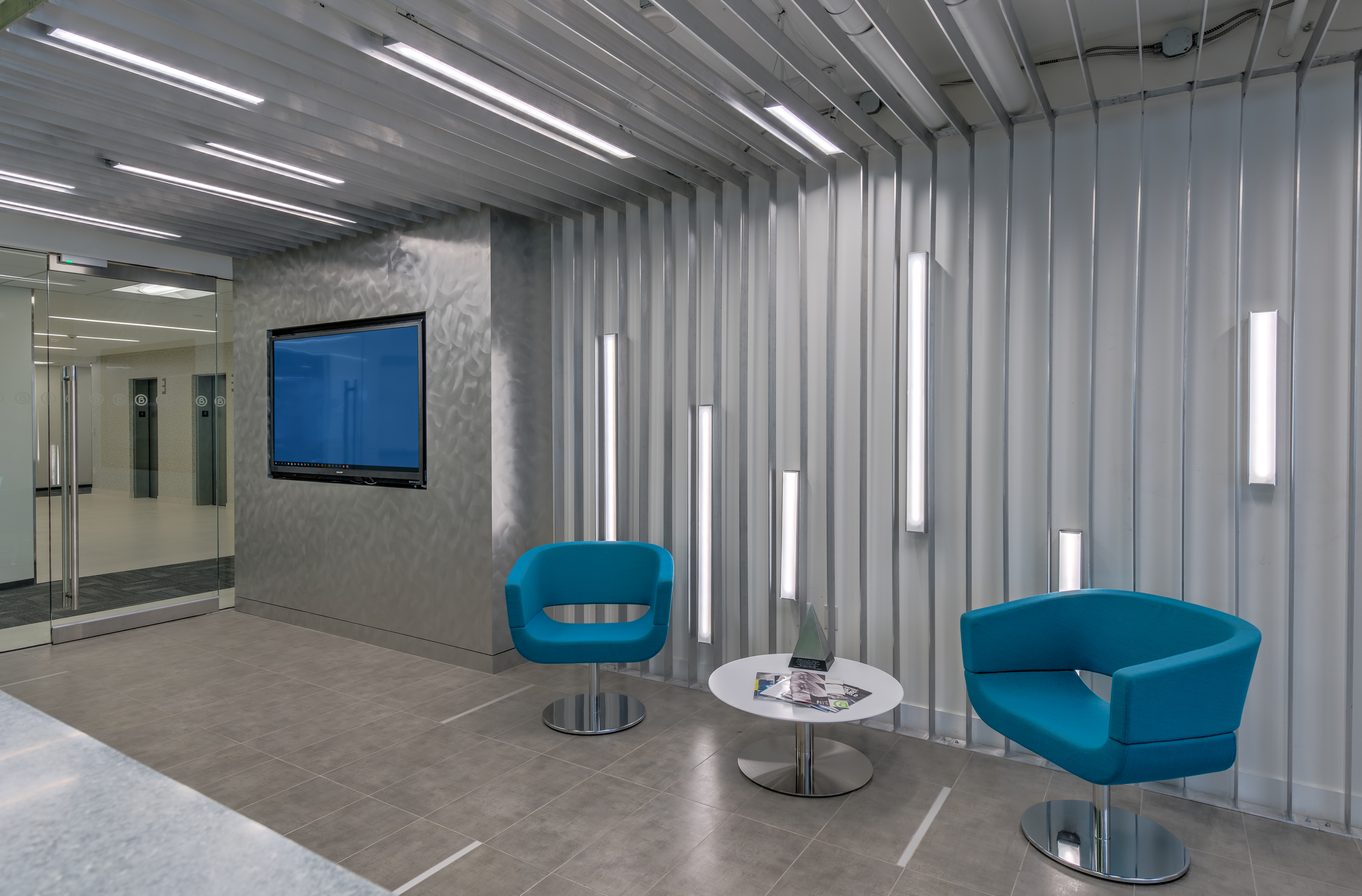 Aluminum Association office lobby with blue chairs and aluminum details