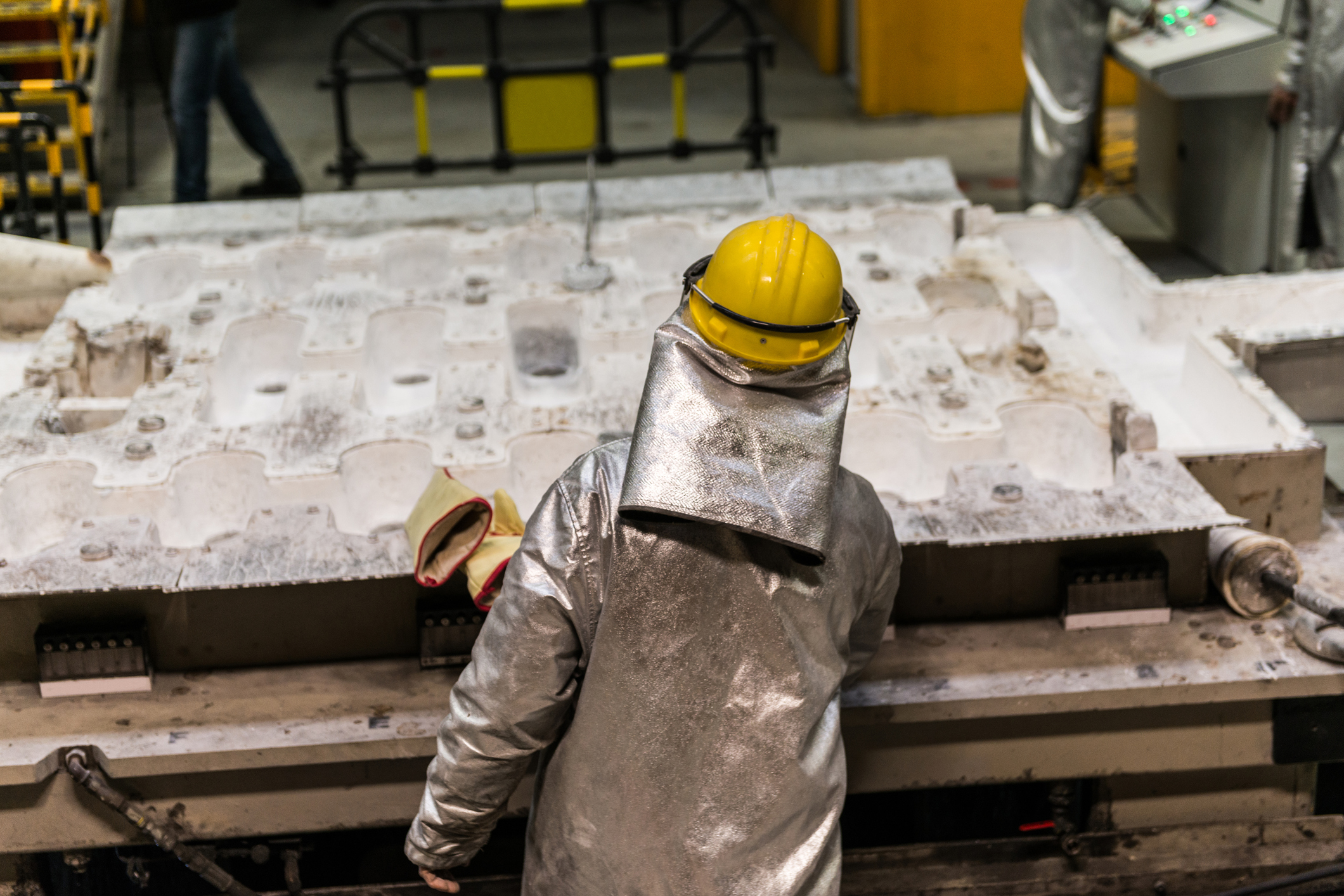 Worker handling molten aluminum