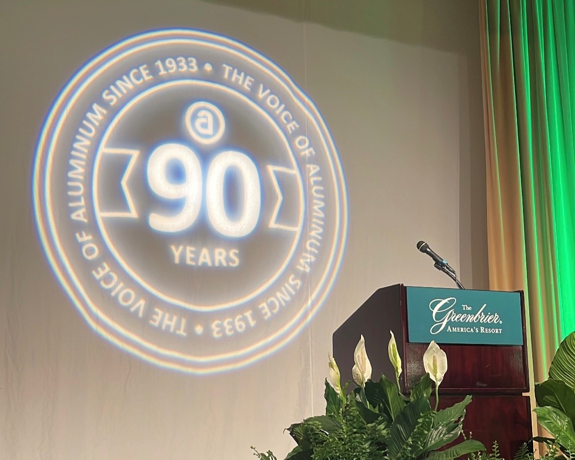 Photo of a podium with "90 Years" behind it